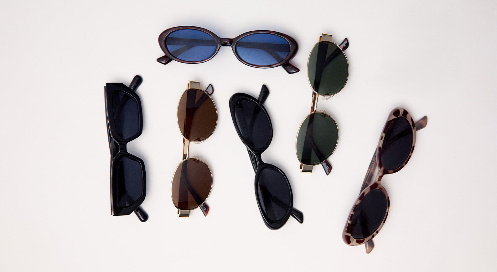 Colección de gafas de sol unisex en diferentes formas y colores sobre fondo blanco