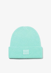 Mint green beanie with a brand logo on a light gray background