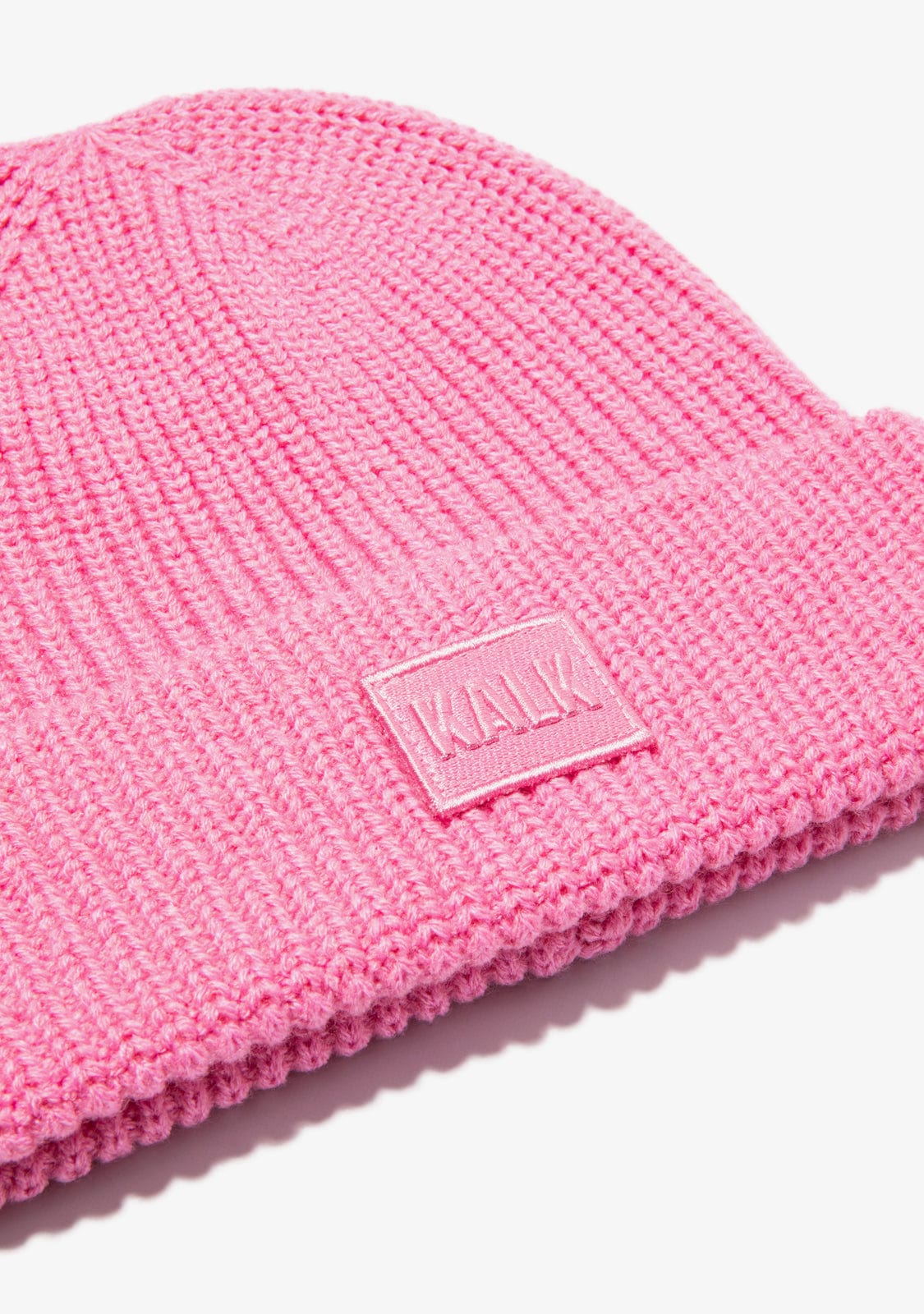 Pink knit beanie with a visible brand logo on a white background
