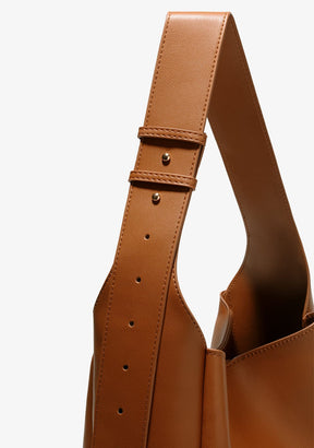 Close-up of a brown leather bucket bag